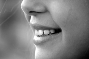 a black and white shot of a smiling girl